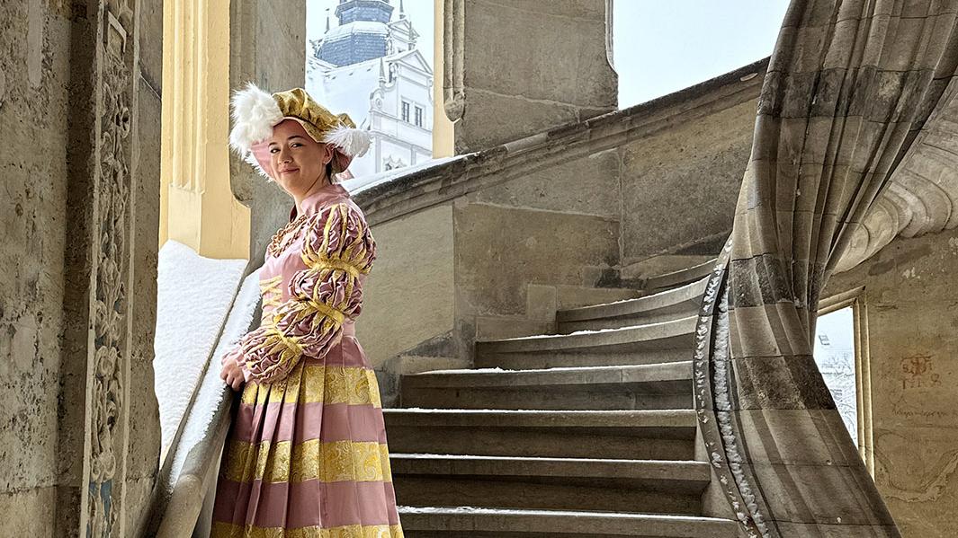 Kurfürstin Sibylle steht in Ihrem Hochzeitskleid vor ihrem Schloss (verkleidete Person)